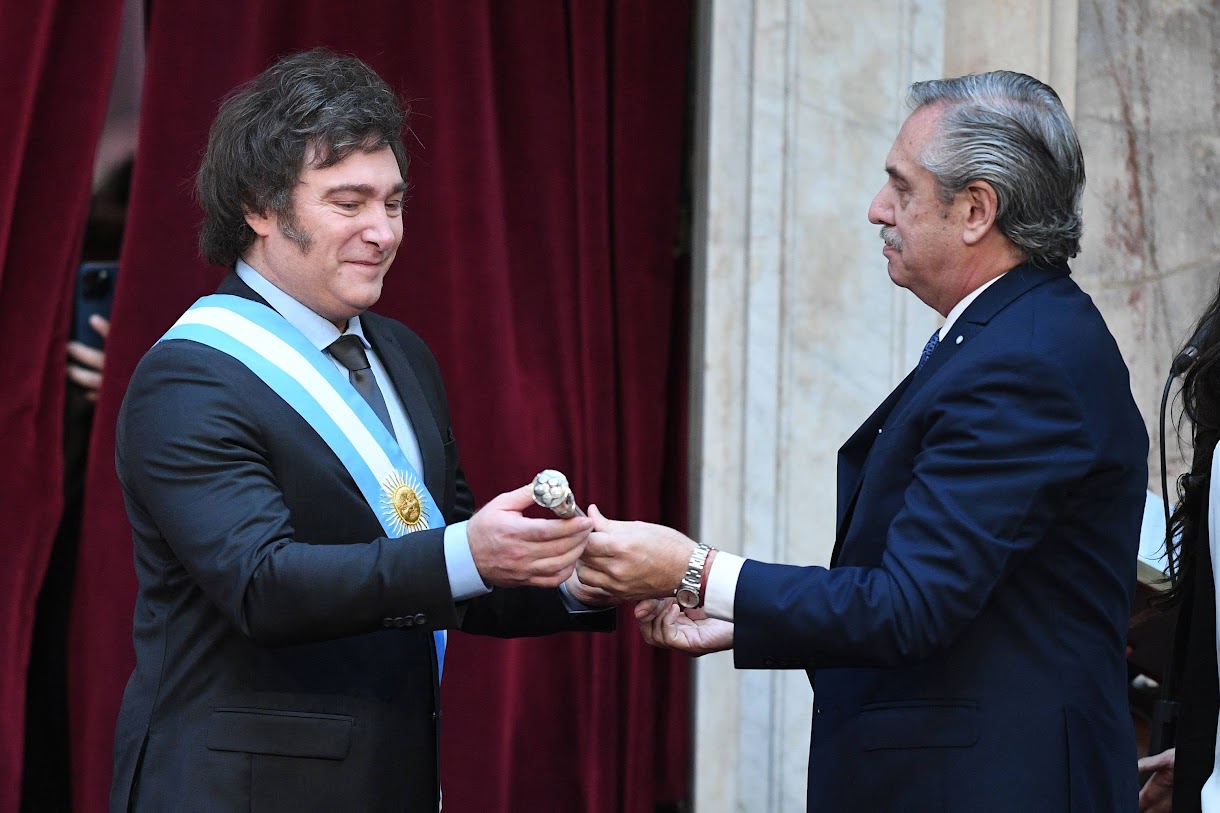 Outgoing president Alberto Fernández handing the presidential sash to Javier Milei