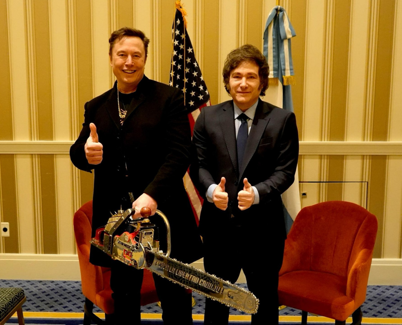 Javier Milei and Elon Musk holding a chainsaw together during a meeting in National Harbor, Maryland, February 2025