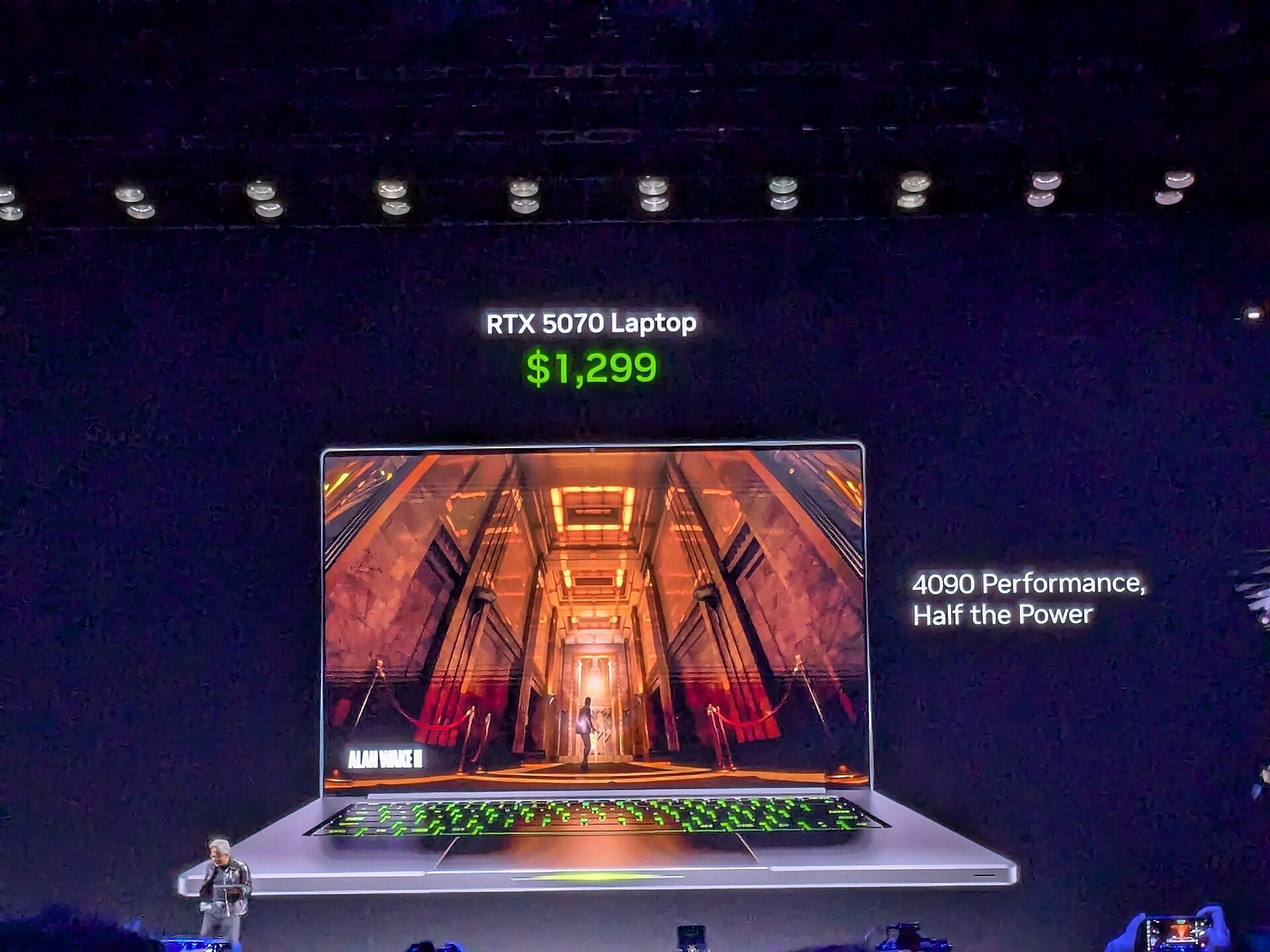 Jensen Huang holding an RTX laptop at the NVIDIA CES 2025 keynote