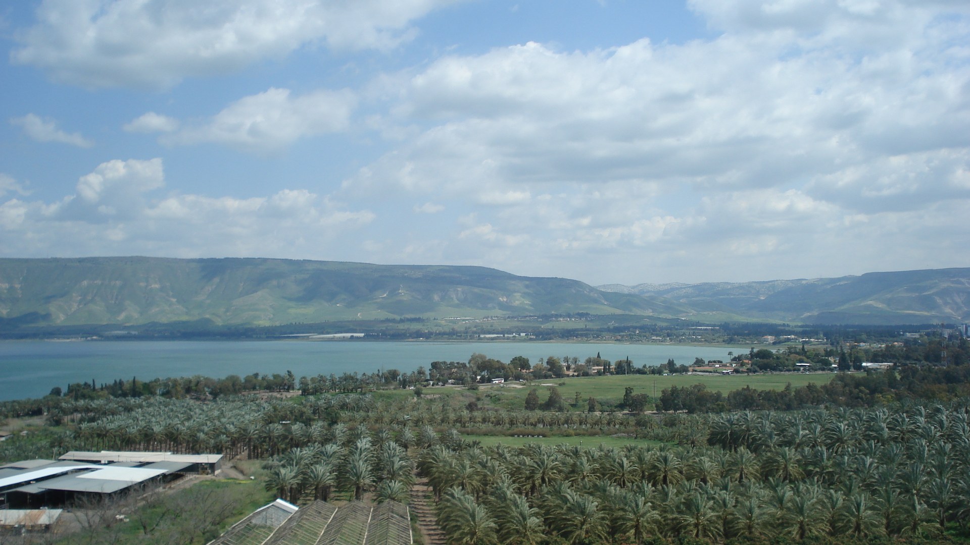 Panoramic view of the Sea of Galilee with calm blue water and hills along the far shore