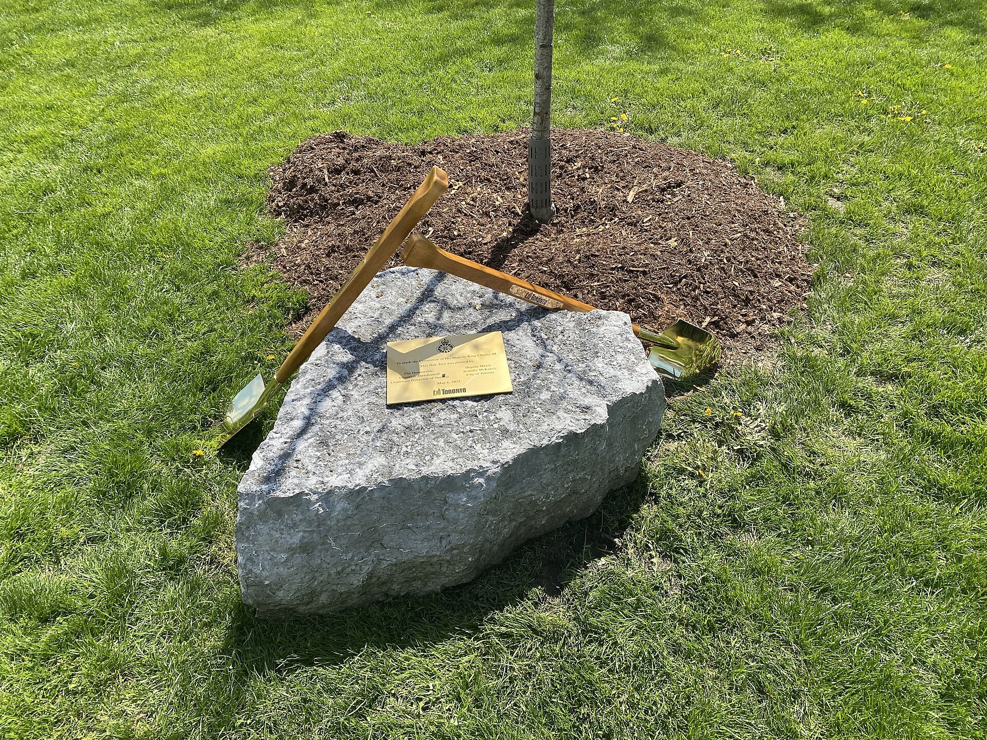Ceremonial shovels and plaque at a coronation tree planting in Toronto, Canada