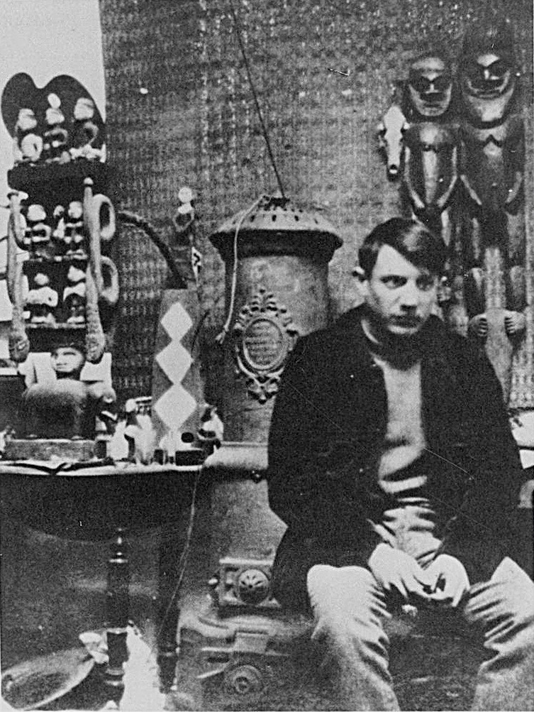 Pablo Picasso in his Montmartre studio in 1908, surrounded by his collection of African sculpture — photograph by Gelett Burgess