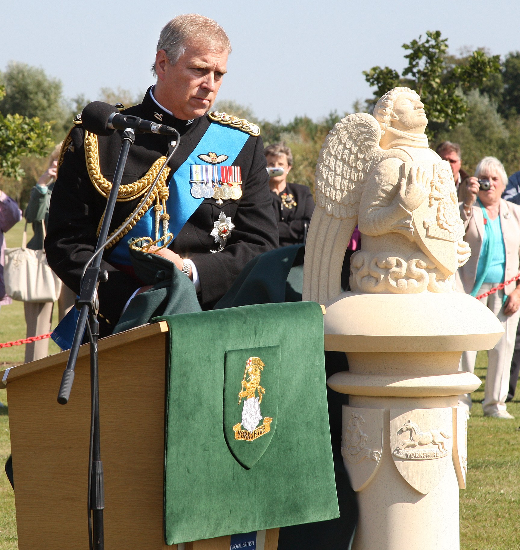 Prince Andrew unveiling a statue during a public engagement