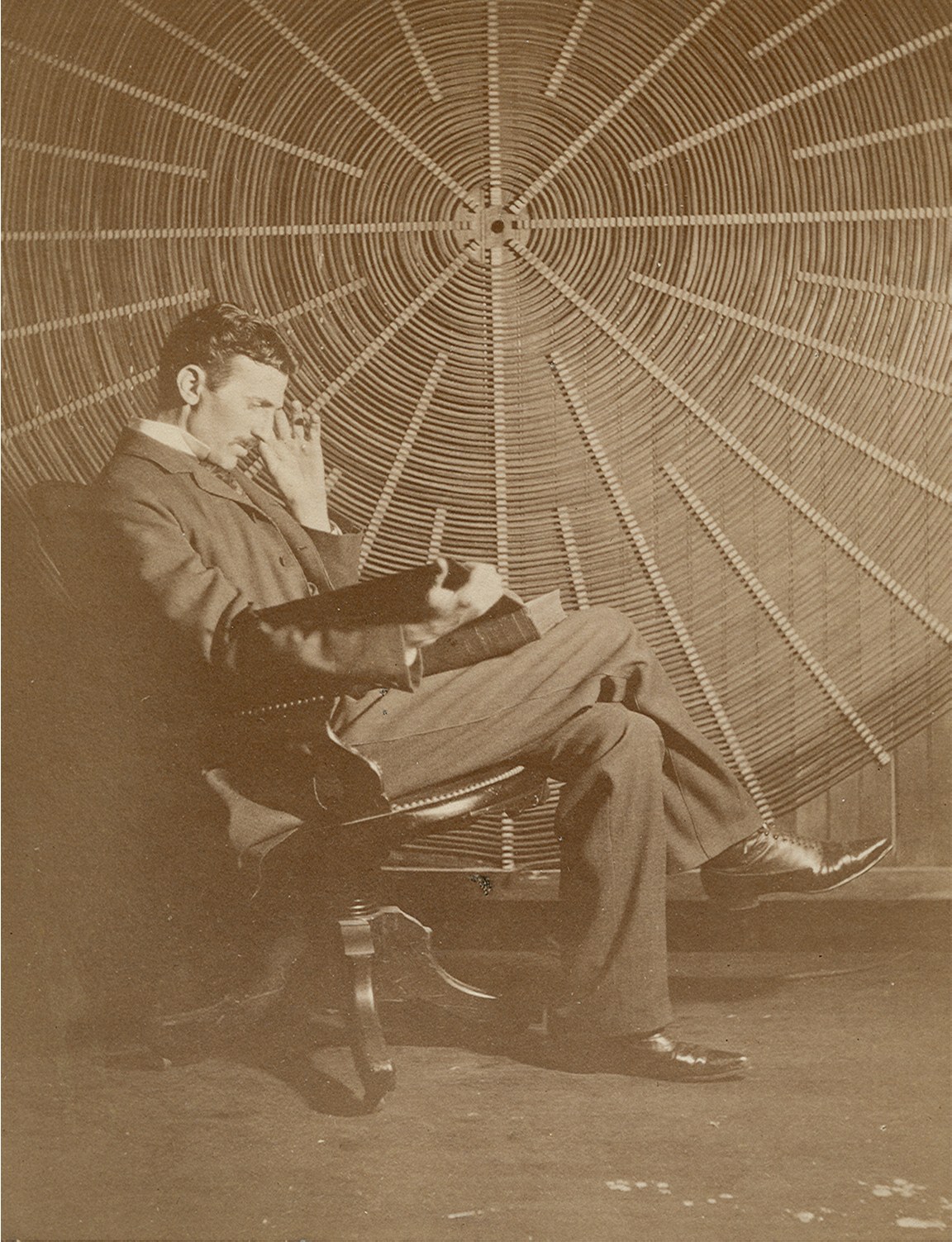 Nikola Tesla in his New York laboratory, surrounded by electrical apparatus